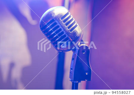 Retro microphone on stage in a pub or American Bar restaurant during a night show. Retro microphone on stage in a pub or American Bar restaurant during a night show. 94558027