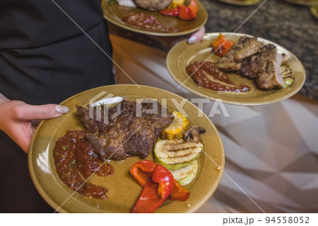 Grilled Steak Striploin and Pepper sauce on cutting board on dark wooden background. Grilled Steak Striploin and Pepper sauce on cutting board on dark wooden background. 94558052