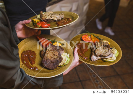 Grilled Steak Striploin and Pepper sauce on cutting board on dark wooden background. Grilled Steak Striploin and Pepper sauce on cutting board on dark wooden background. 94558054