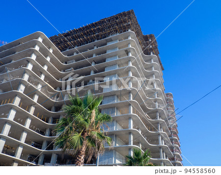 Hotel under construction on the beach. Black Sea coast. Construction industry. Building frame. 94558560