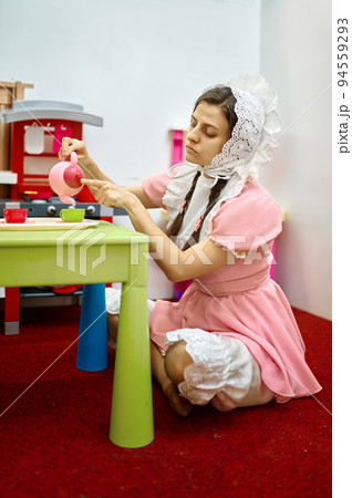 Funny woman like baby playing tea party Funny woman like baby playing tea party 94559293