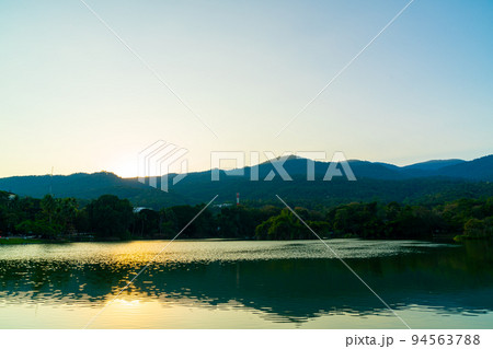 Ang Kaew lake at Chiang Mai University with forested mountain Ang Kaew lake at Chiang Mai University with forested mountain 94563788