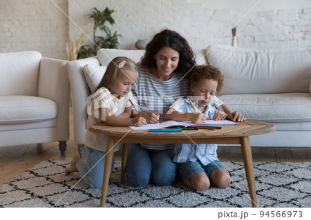 Loving mother drawing with pencils with preschoolers kids at home Loving mother drawing with pencils with preschoolers kids at home 94566973