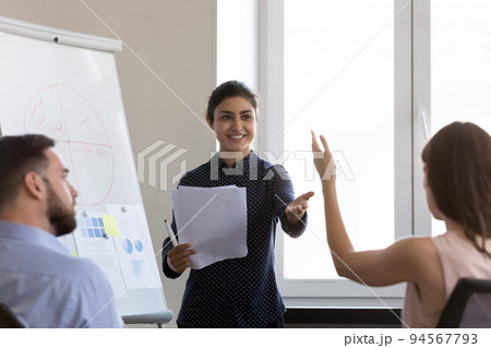 Happy young Indian business coach woman getting question from audience 94567793