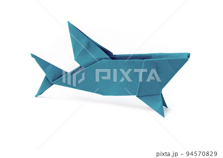 Blue paper shark origami isolated on a white background Blue paper shark origami isolated on a white background 94570829