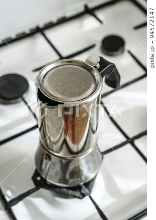 Metal coffee maker for brewing espresso coffee on the stove. Alternative brewing methods Metal coffee maker for brewing espresso coffee on the stove. Alternative brewing methods 94572147