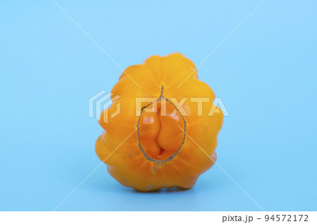 Ugly vegetables concept. Tomatoes of various unusual shapes on a blue minimal background. A metaphor for imperfection, the female body, the art of photography and form. 94572172
