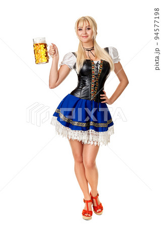 Full length portrait of a blond woman with traditional costume holding beer glasses isolated on white background. Full length portrait of a blond woman with traditional costume holding beer glasses isolated on white background. 94577198