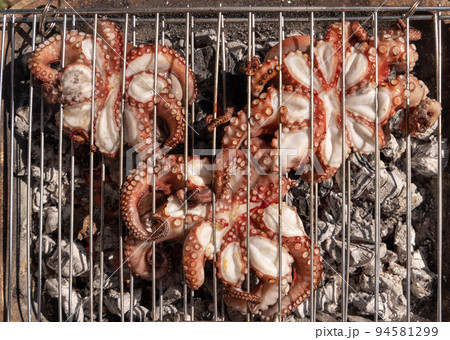 Fresh octopuses on the charcoal grill, Italy. Traditional Mediterranean cuisine. Fresh octopuses on the charcoal grill, Italy. Traditional Mediterranean cuisine. 94581299