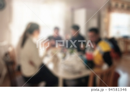 Group of friends having fun with eating food and talking on dining table at weekend Group of friends having fun with eating food and talking on dining table at weekend 94581346