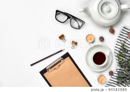 Opened diary with pen on the table near hot cup of black tea Opened diary with pen on the table near hot cup of black tea 94582989