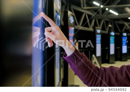 Woman hand using touchscreen display of interactive kiosk at exhibition 94584092