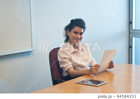 Business woman examining contract agreement in office 94584351