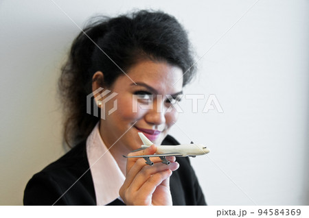 Business woman hold plane model toy on hand 94584369