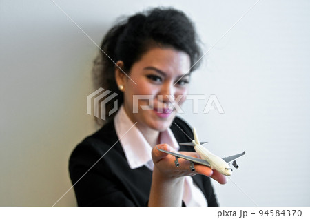 Business woman hold plane model toy on hand Business woman hold plane model toy on hand 94584370