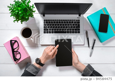 Overhead view of businesswoman working at computer in office 94584475