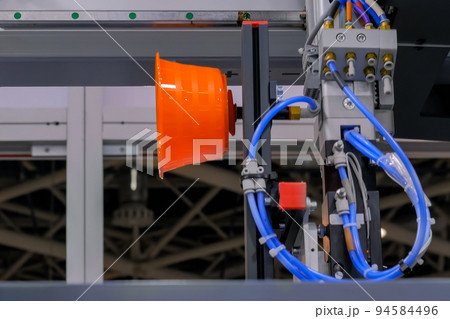 Automatic robotic arm manipulator with suction cups moves plastic pots at fabric 94584496