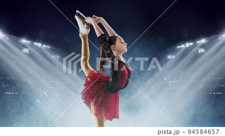 Little girl, figure skater wearing beautiful dress performing short program over ice arena background. Dance, winter sports, achievements, champion concept 94584657