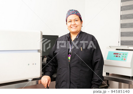 Female scientist working at the laboratory with a thermal cycler. Polymerase chain reaction technique. PCR technique Female scientist working at the laboratory with a thermal cycler. Polymerase chain reaction technique. PCR technique 94585140