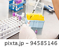 Scientist preparing bone marrow samples for flow cytometric analysis in the laboratory. 94585146