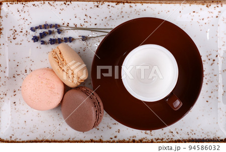French macaroon cookies and brown coffee cup French macaroon cookies and brown coffee cup 94586032