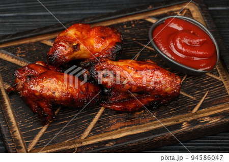 Barbecue chicken buffalo wings sauce on wood 94586047