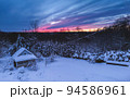 Forest cabin and trees in winter sunset. Wooden hut in the snow. forest on the evening sky background 94586961