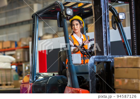 women worker at forklift driver happy working in industry factory logistic ship.  94587126