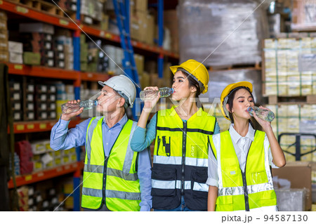 Worker drinking water in factory site. 94587130