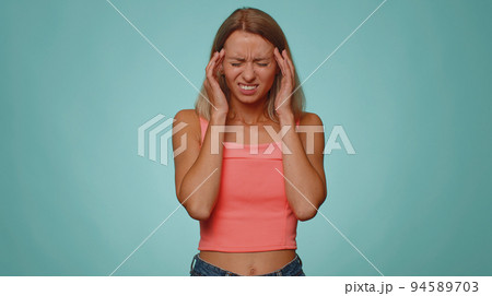 Woman rubbing temples to cure headache problem, suffering from tension and migaine, stress, pain 94589703