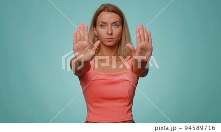 Woman say no hold palm folded crossed hands in stop gesture, warning of finish, prohibited access Woman say no hold palm folded crossed hands in stop gesture, warning of finish, prohibited access 94589716