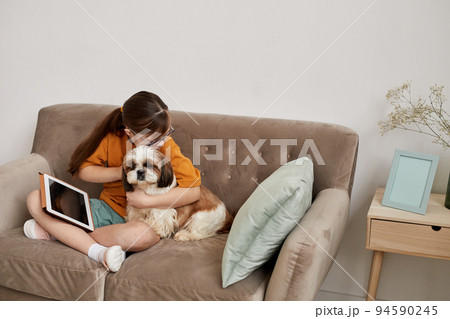 Girl With Down Syndrome Hugging Dog Girl With Down Syndrome Hugging Dog 94590245
