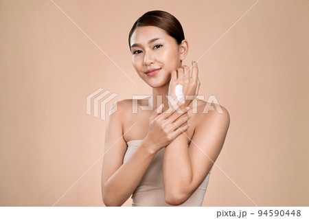 Ardent girl with soft makeup applying moisturizing skincare cream on her hand. Ardent girl with soft makeup applying moisturizing skincare cream on her hand. 94590448