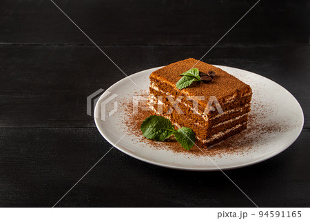 Italian dessert tiramisu on dark background. Italian dessert tiramisu on dark background. 94591165