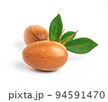Argan nuts with green leaves on isolated white background. Moroccan Argania Spinosa seeds for the production of oil 94591470