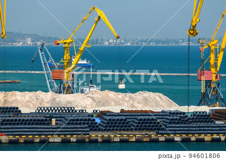industrial seaport infrastructure, sea, cranes and minerals, metal and bundles of wire, the concept of marine cargo transportation 94601806