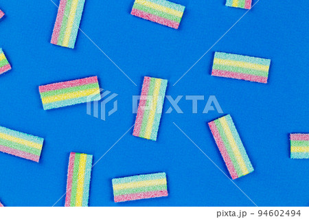 Licorice Candy. Sweet gummy sticks with different flavor, on blue background. 94602494