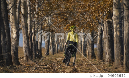 The woman travel on mixed terrain cycle touring with bikepacking. The traveler journey with bicycle bags. Sport tourism bikepacking. 94603652