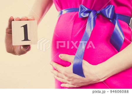 Hand of woman showing number of first month of pregnancy, expecting for newborn concept 94606088
