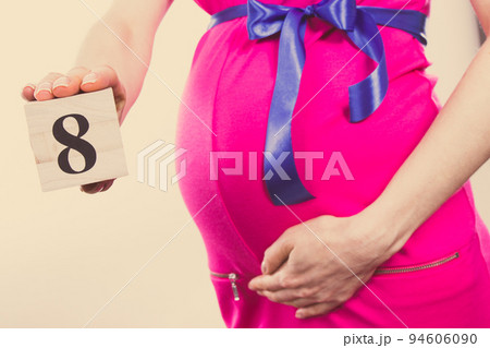 Hand of woman showing number of eighth month of pregnancy, expecting for newborn concept 94606090