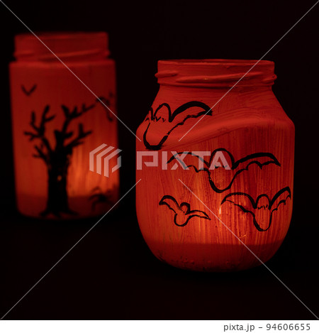 Hand painted jar for Halloween, jar of orange color on a black background. Hand painted jar for Halloween, jar of orange color on a black background. 94606655