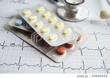 Stethoscope on electrocardiogram (ECG) with drug, heart wave, heart attack, cardiogram report. 94606836