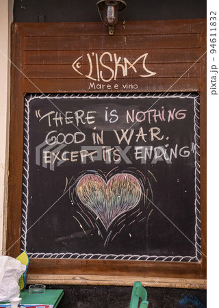 Catalina, Sicily, Italy. August 26, 2022. Beautiful quote written on chalkboard. Signboard with words of wisdom mounted on wooden wall outside cafe. Concept of motivation. 94611832
