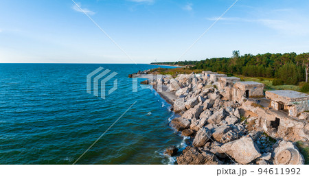 Ruins of bunkers on the beach of the Baltic sea, part of an old fort in the former Soviet base Karosta in Liepaja, Latvia. Sunset landscape. 94611992