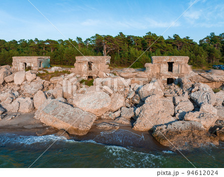 Ruins of bunkers on the beach of the Baltic sea, part of an old fort in the former Soviet base Karosta in Liepaja, Latvia. Sunset landscape. 94612024