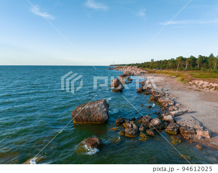 Ruins of bunkers on the beach of the Baltic sea, part of an old fort in the former Soviet base Karosta in Liepaja, Latvia. Sunset landscape. 94612025