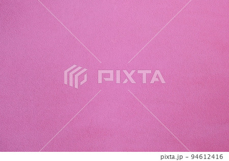 The blanket of furry pink fleece fabric. A background texture of light pink soft plush fleece material The blanket of furry pink fleece fabric. A background texture of light pink soft plush fleece material 94612416