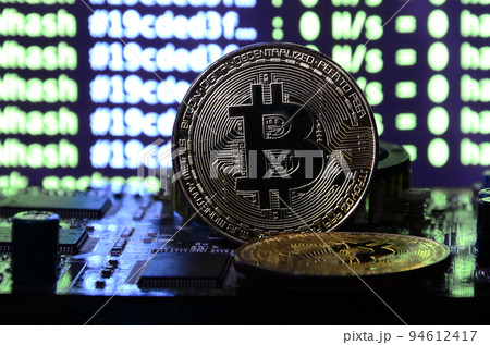 The digital process of cryptocurrency mining by using the GPUs. Bitcoins and video card on a working display and mining screen The digital process of cryptocurrency mining by using the GPUs. Bitcoins and video card on a working display and mining screen 94612417