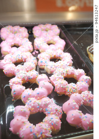 pink color chocolate donuts display for sale at local store pink color chocolate donuts display for sale at local store 94613247