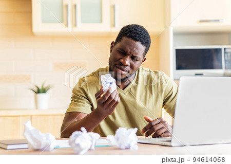 Man crushed paper while working and have no idea remote work in kitchen Man crushed paper while working and have no idea remote work in kitchen 94614068